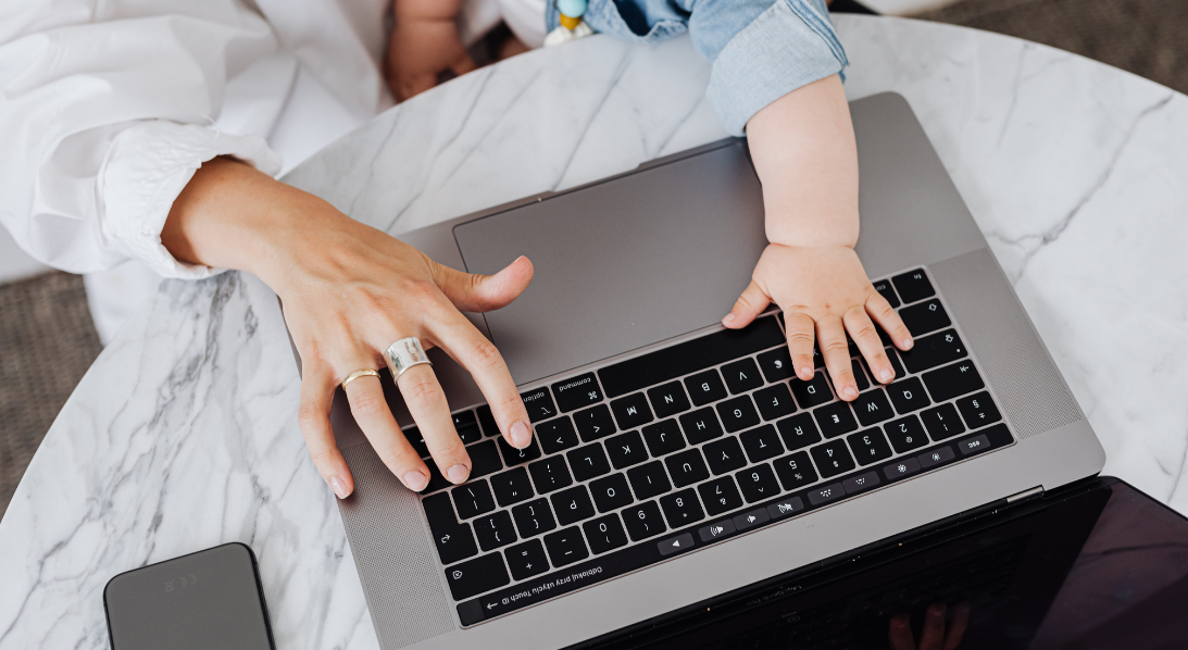 Baby typing with adult