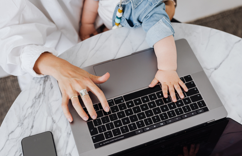 Baby typing with adult